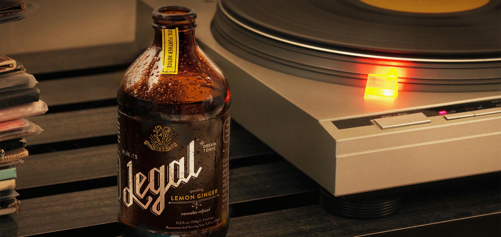 Legal Lemon Ginger tonic next to a vinyl turntable